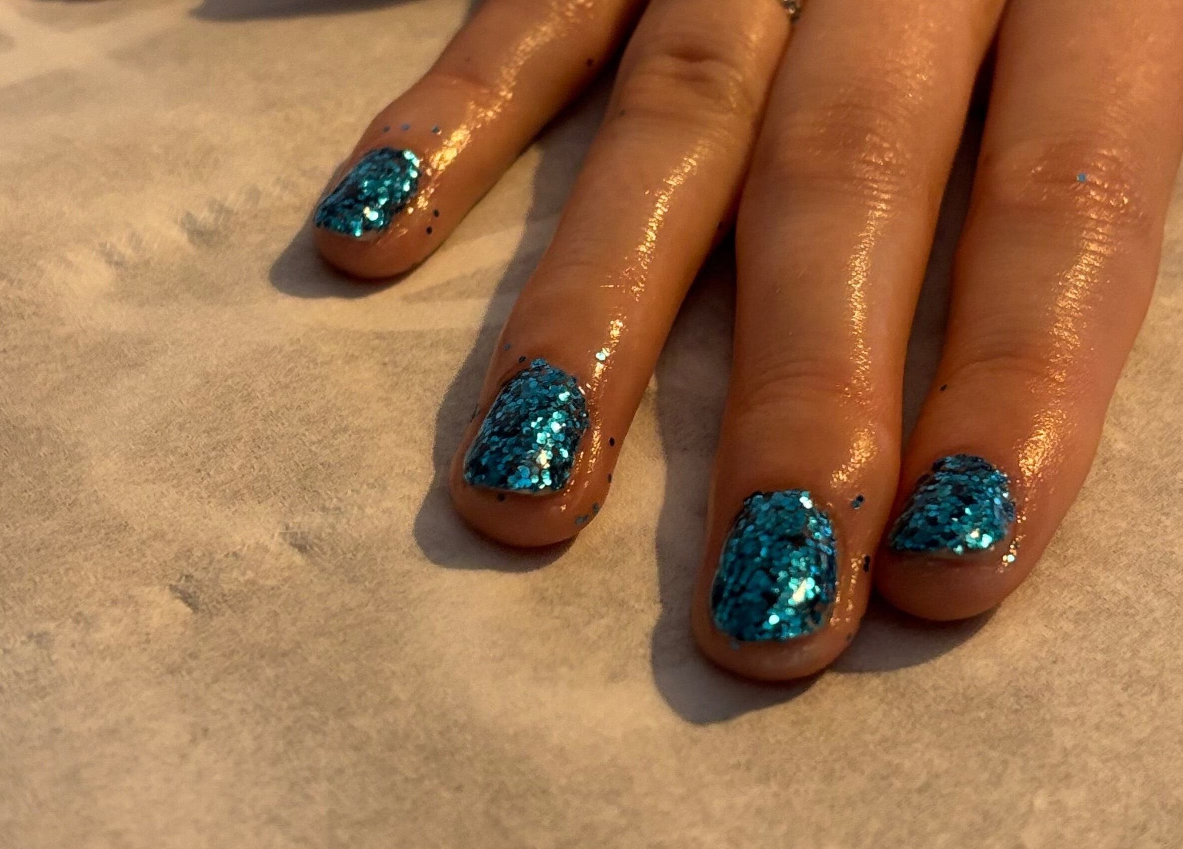 Close-up of glittery blue nails at Beauty and Beyond, Greenock, Scotland, GB.