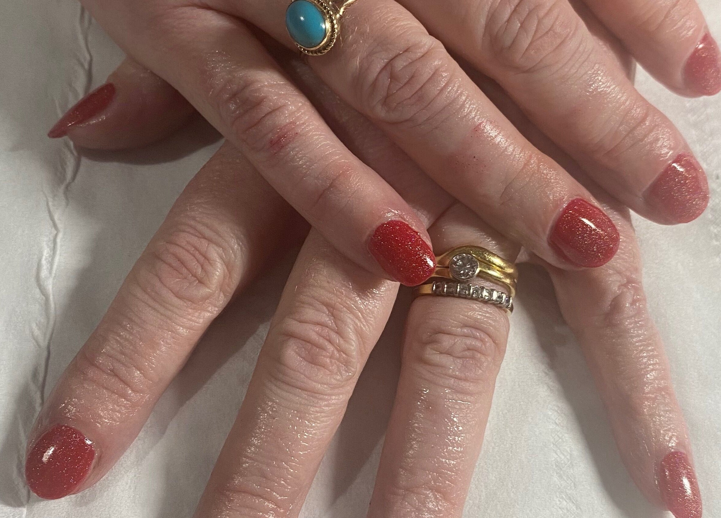 Elegant red manicured nails by Beauty and Beyond in Greenock, Scotland, GB, showcasing luxury and style.