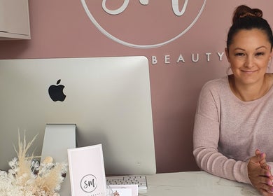 Welcoming smile at SM Skin and Beauty reception in Strathmore, Victoria, AU with serene decor.