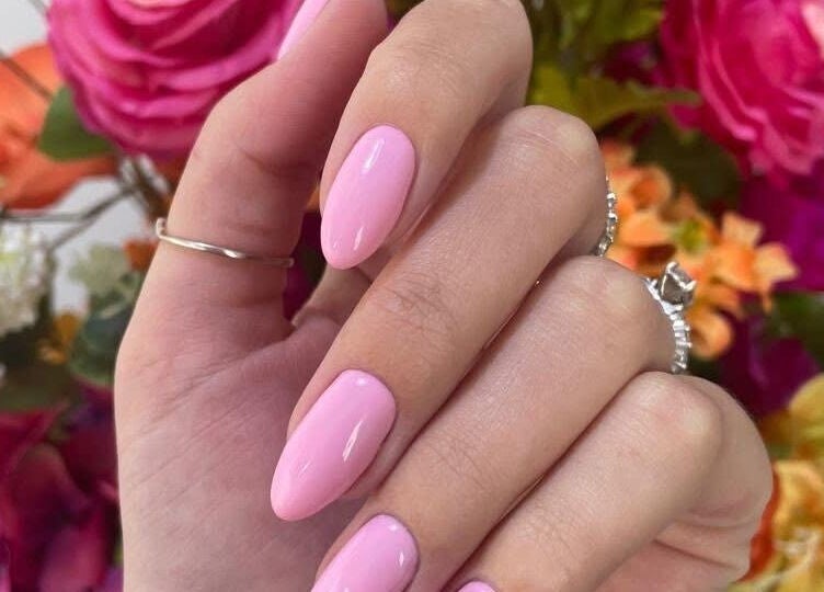 Elegant pink nail art at Skoonveldt, Klerksdorp, North West, ZA with vibrant floral background.