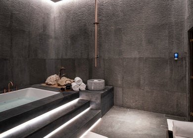 Luxurious spa room at SENSASIA Stories, Dubai, Dubai, AE featuring a modern bathtub and minimalist decor.