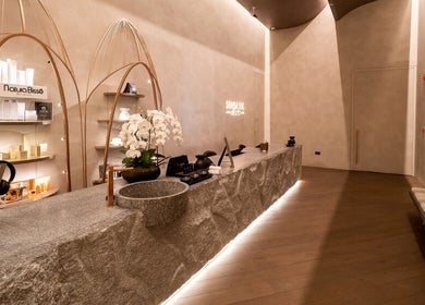 Elegant reception area of SENSASIA Stories in Dubai, Dubai, AE with a modern natural stone counter and decor.