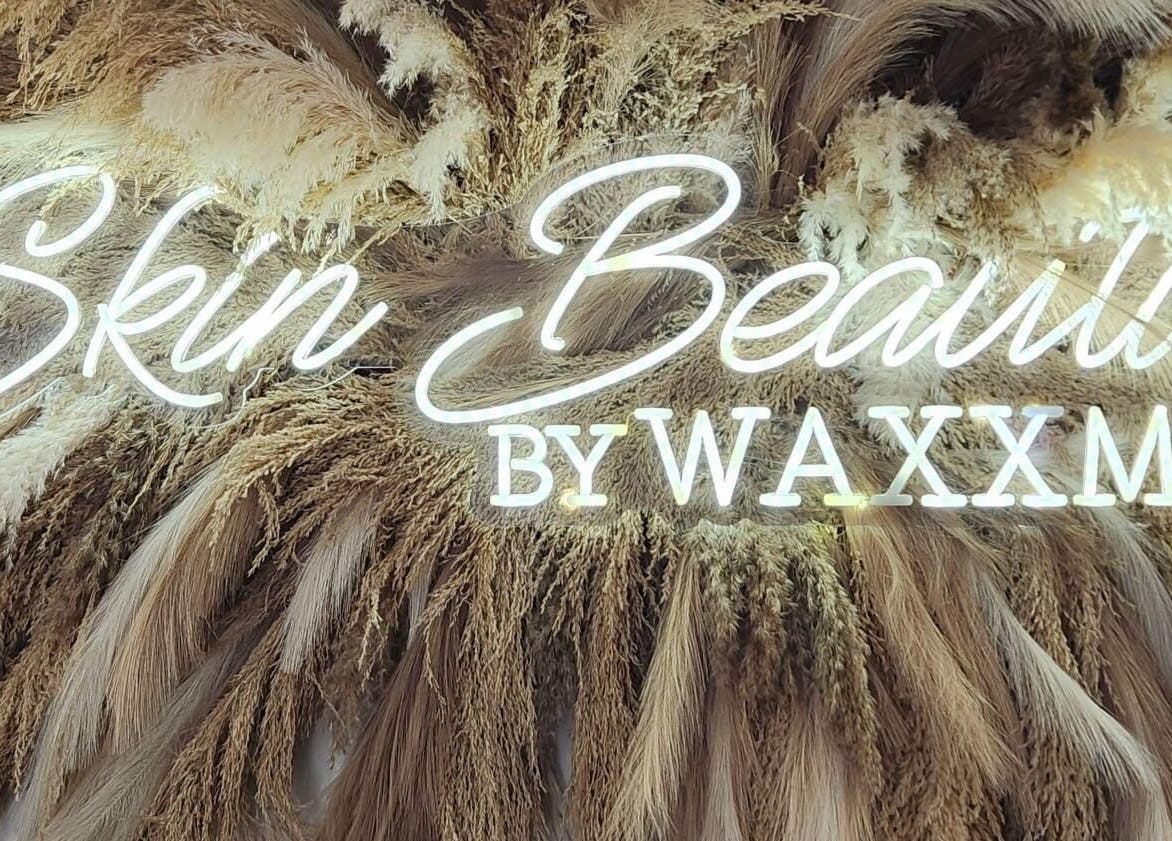 Illuminated Skin Beautii by Waxxmii sign with pampas background at Mackey Street, Nassau, New Providence, BS.