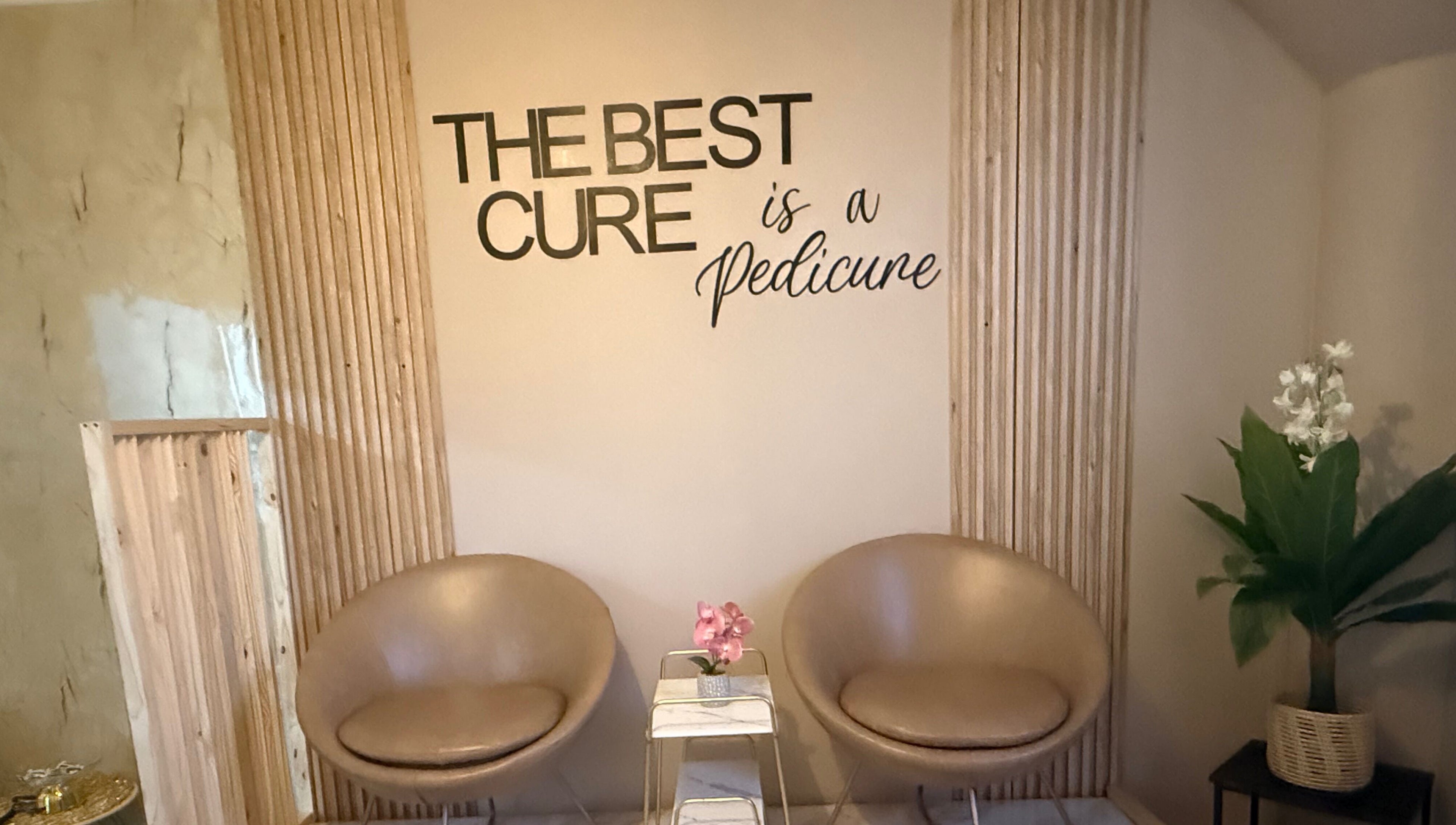 Cozy seating at Goddess Glow Pedi & Wax Bar, Cape Town, Western Cape, ZA with 'The Best Cure is a Pedicure' sign.