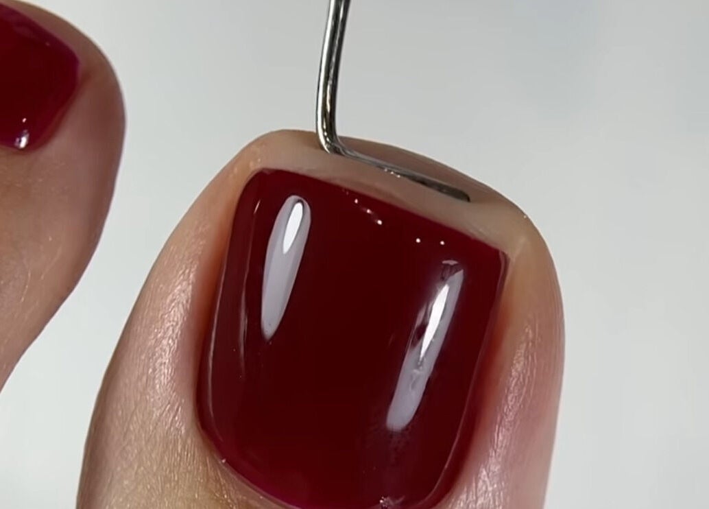 Close-up of vibrant crimson pedicure at Goddess Glow Pedi & Wax Bar, Cape Town, Western Cape, ZA.