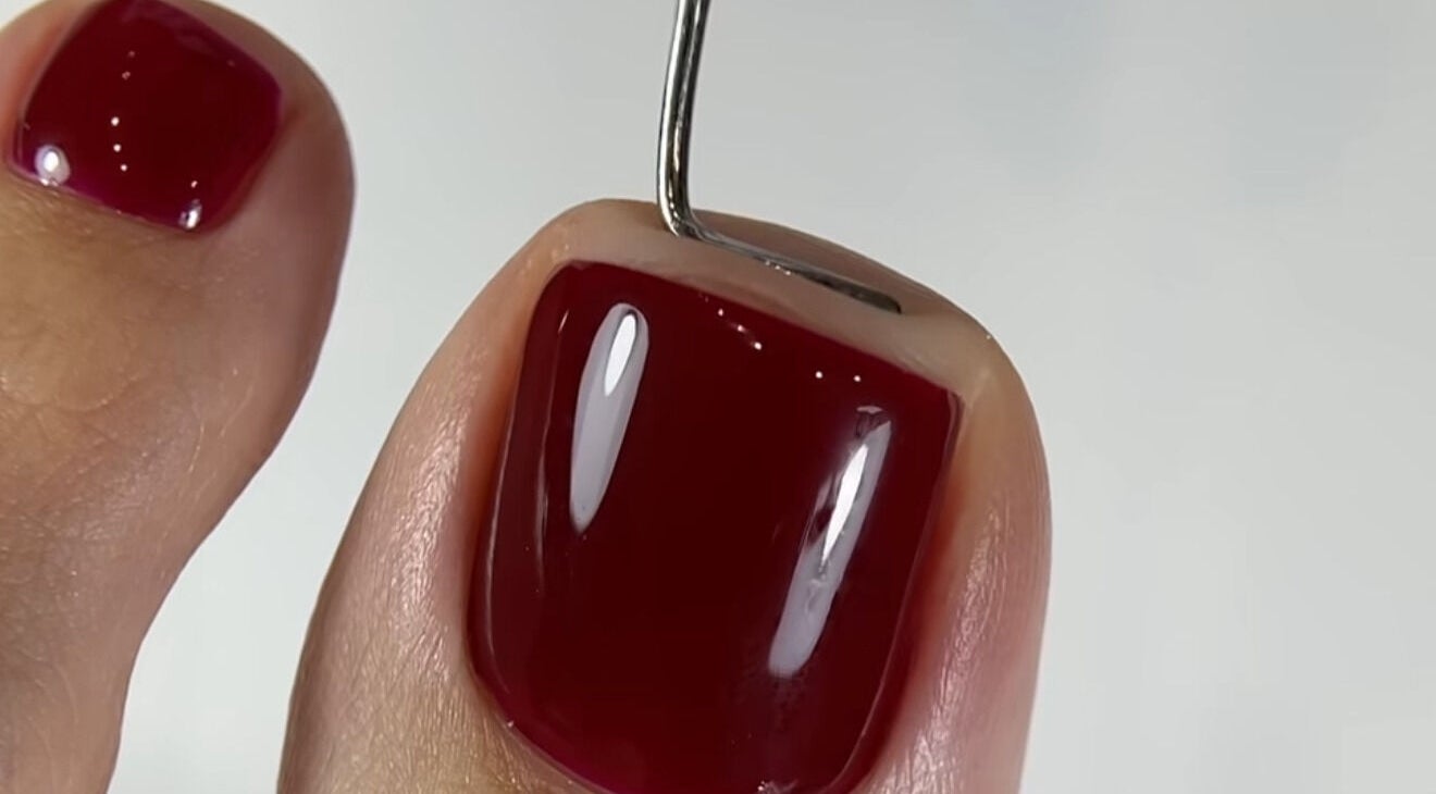 Close-up of vibrant crimson pedicure at Goddess Glow Pedi & Wax Bar, Cape Town, Western Cape, ZA.