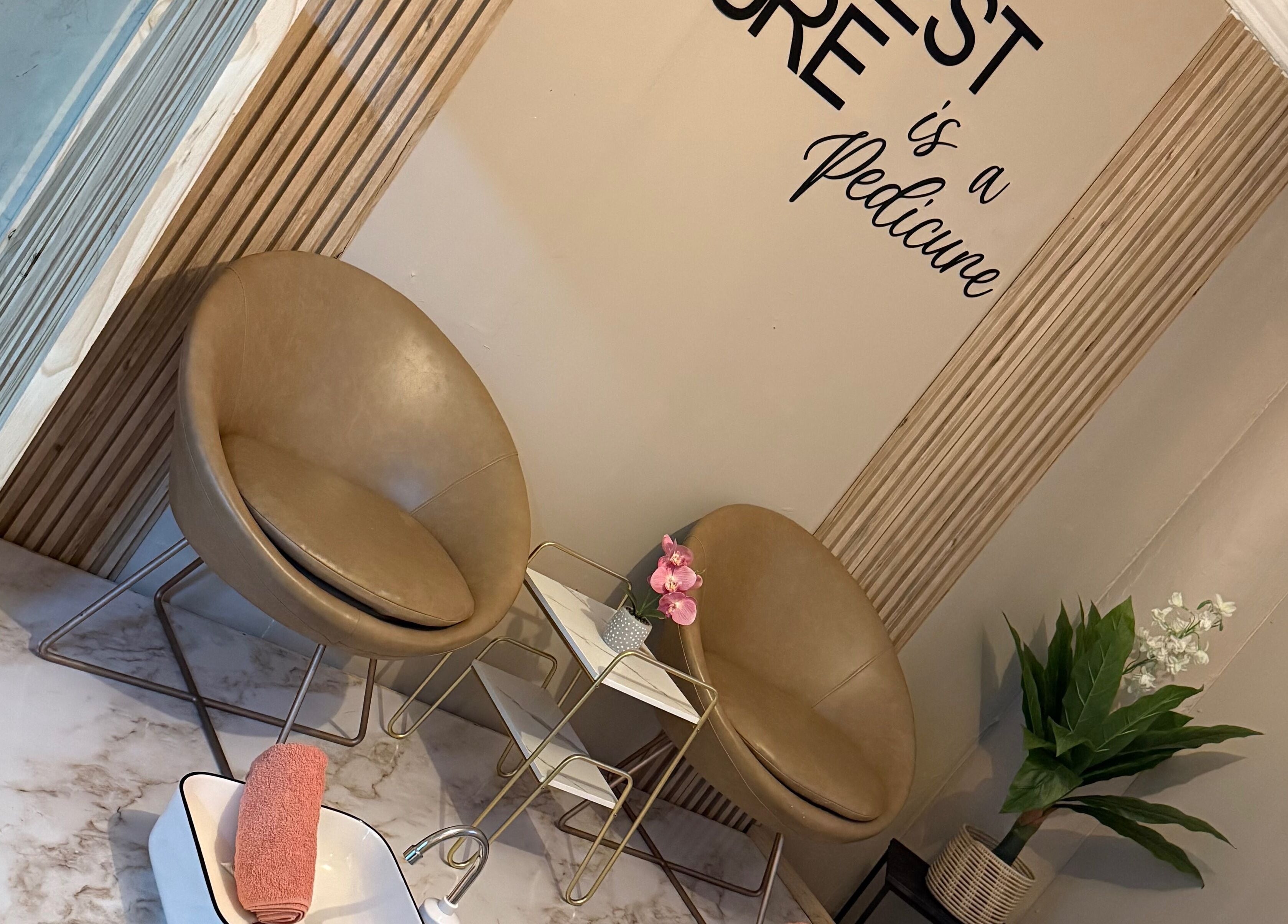 Elegant seating area at Limitless Beauty, Cape Town, Western Cape, ZA with tan chairs and decor.