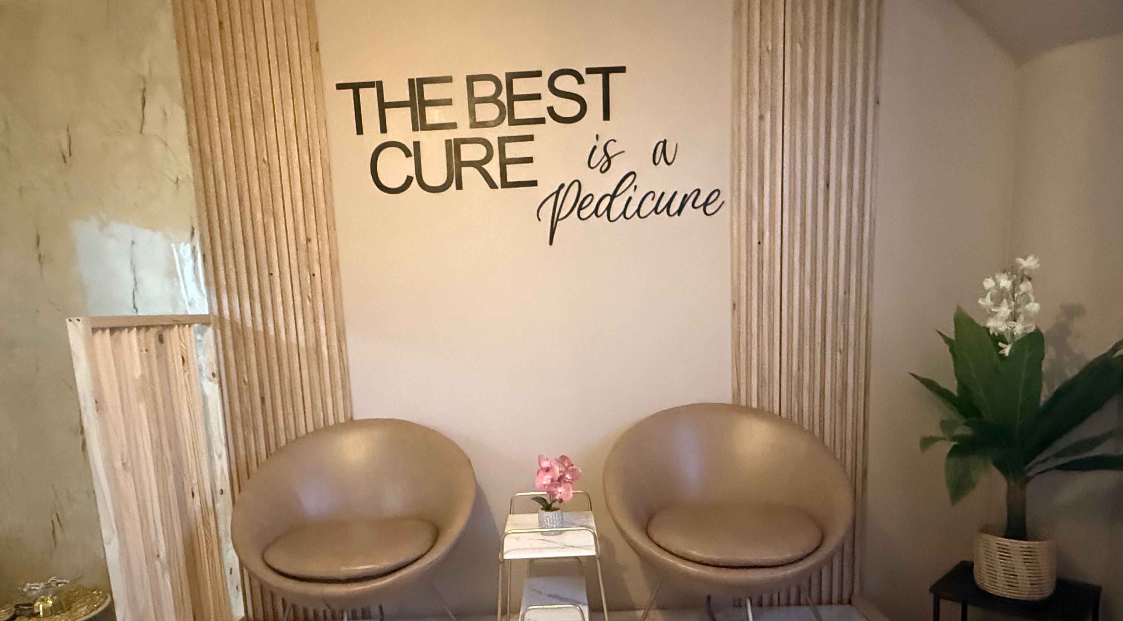 Stylish waiting area at Goddess Glow Pedi & Wax Bar, Cape Town, Western Cape, ZA, with modern chairs and decor.
