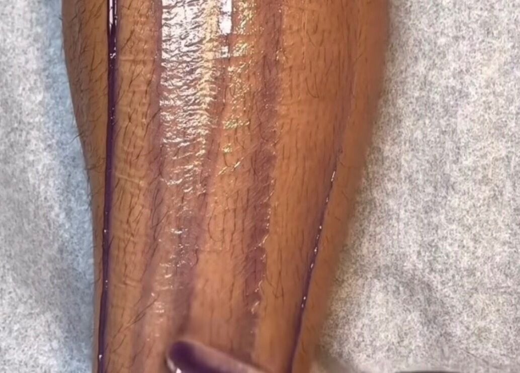 Leg being waxed at Goddess Glow Pedi & Wax Bar, Cape Town, Western Cape, ZA for smooth skin.