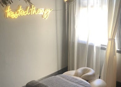 Cozy therapy room at Tessted Therapy, Alexandria, NSW, AU, featuring a massage table and soft lighting.