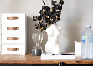 Elegant decor at Tessted Therapy, featuring a modern bust, water bottle, and drawers in Alexandria, New South Wales, AU.
