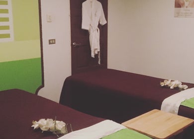 Relaxing spa room at The J Spa & Skin Clinic Ltd in San Fernando City Corporation, featuring massage tables.