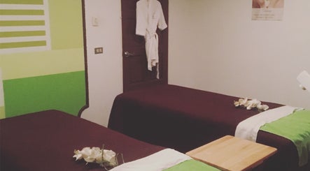 Relaxing spa room at The J Spa & Skin Clinic Ltd in San Fernando City Corporation, featuring massage tables.