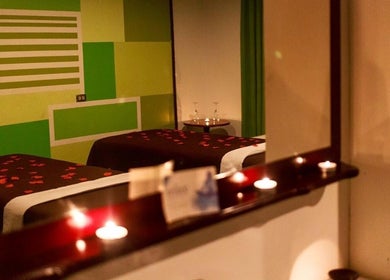 Cozy treatment room at The J Spa & Skin Clinic Ltd, San Fernando, featuring relaxing candles and calm ambiance.