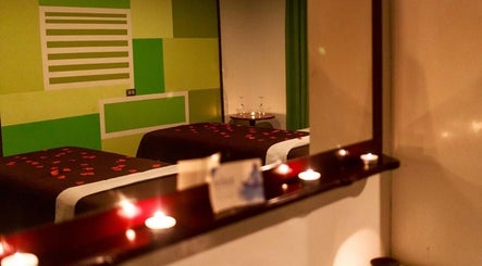 Cozy treatment room at The J Spa & Skin Clinic Ltd, San Fernando, featuring relaxing candles and calm ambiance.