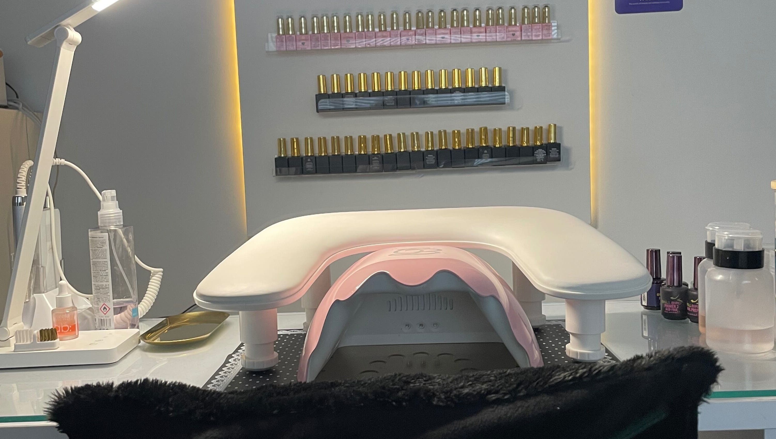 Manicure station at The Glam and Glow Studio, Havant, England, showcasing nail polish selections.