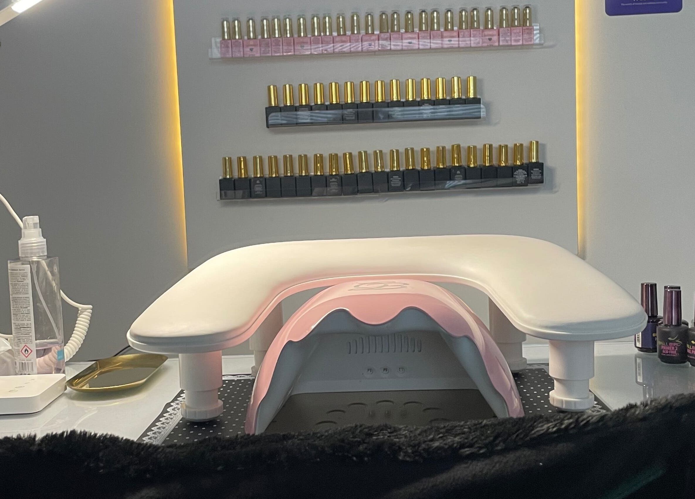 Manicure station at The Glam and Glow Studio, Havant, England, showcasing nail polish selections.
