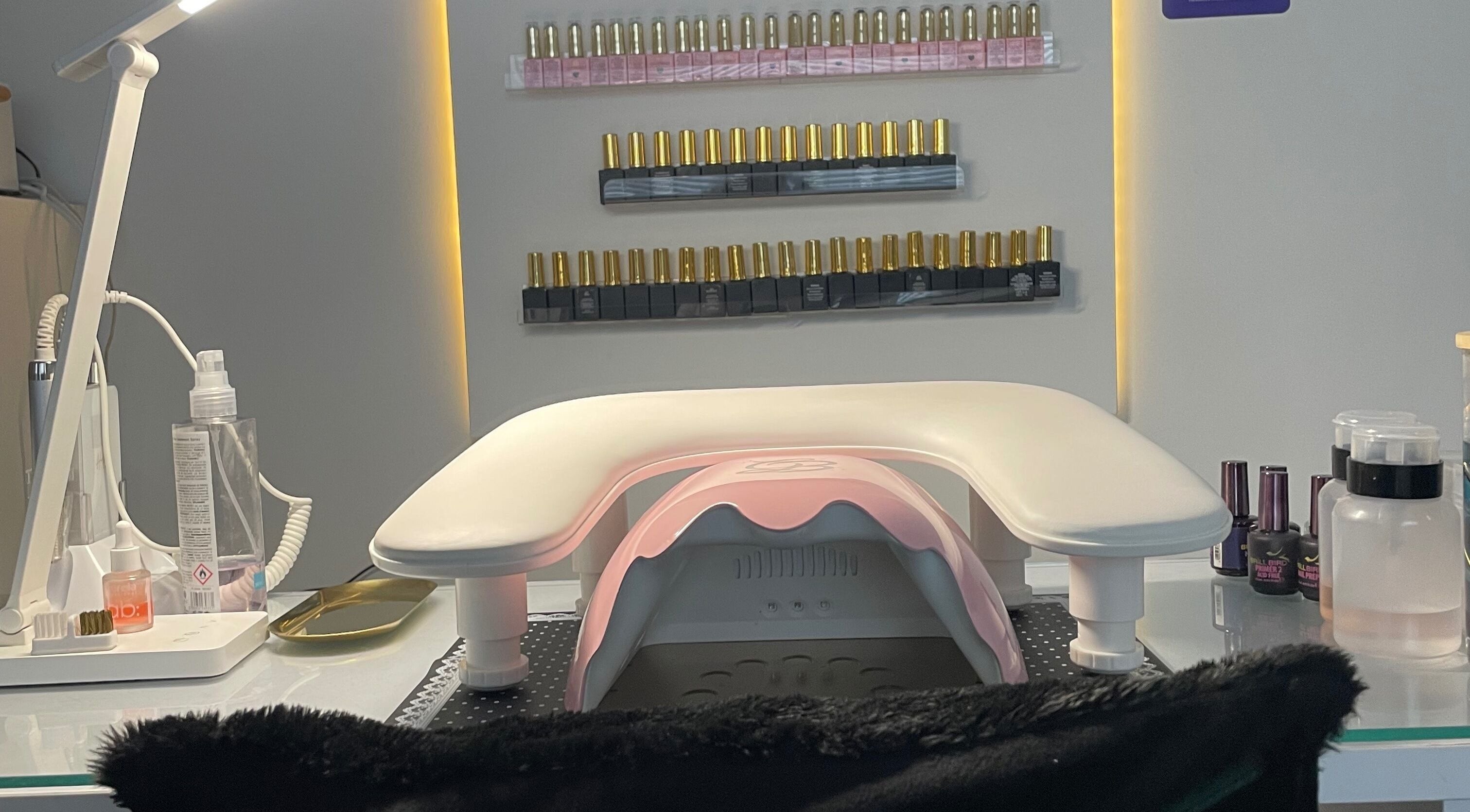 Manicure station at The Glam and Glow Studio, Havant, England, showcasing nail polish selections.