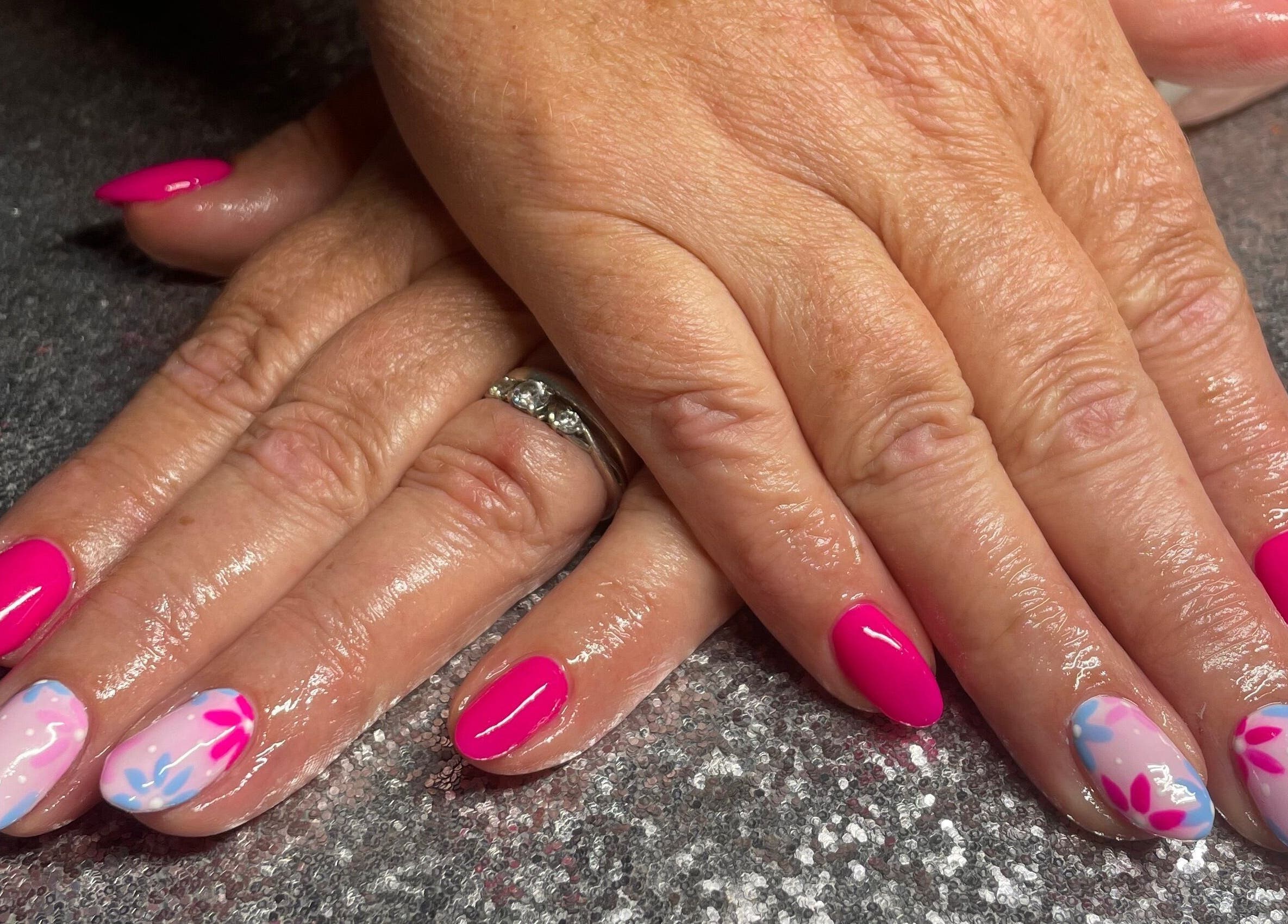 Stylish pink and floral nail art at The Glam and Glow Studio in Havant, England, GB.