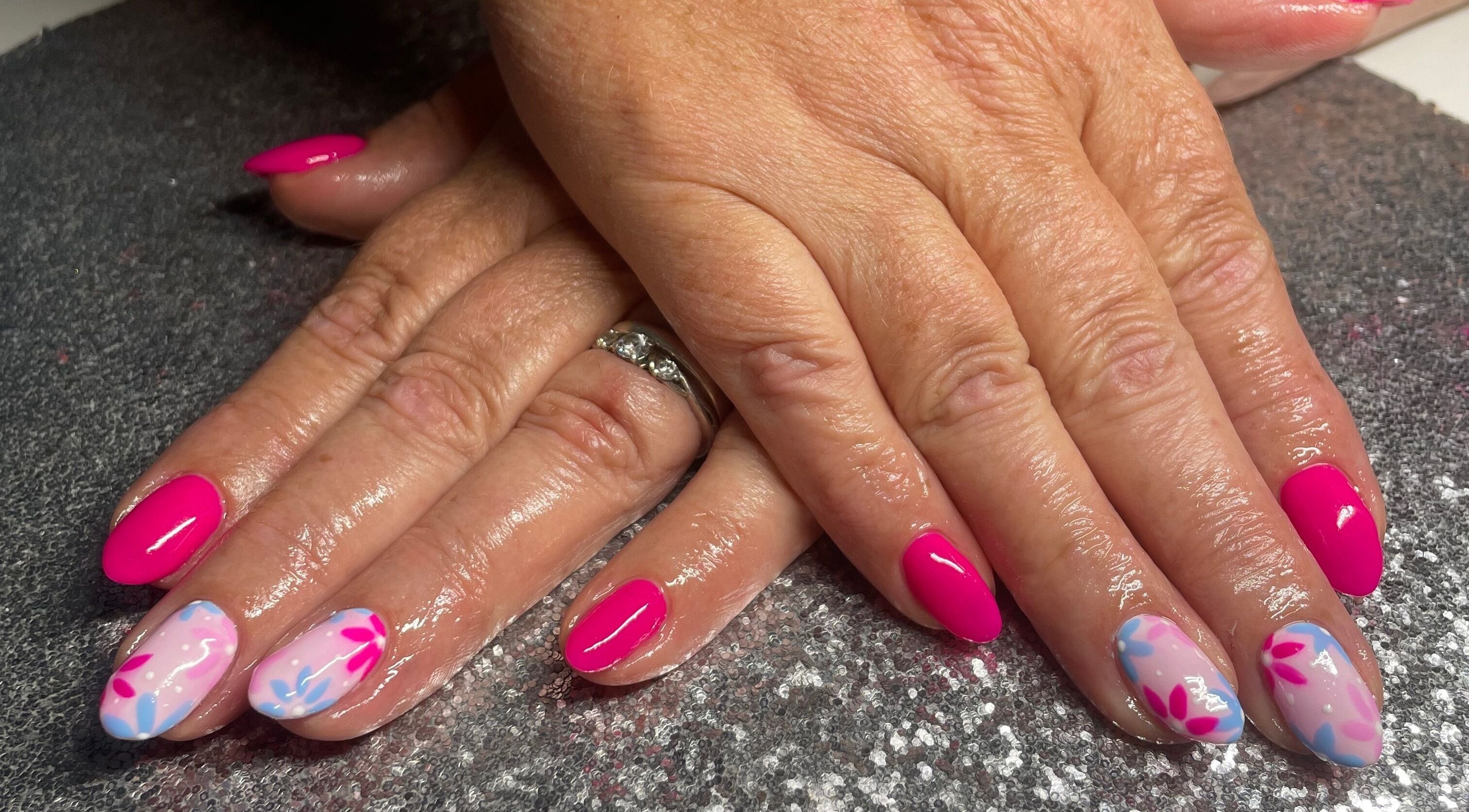 Stylish pink and floral nail art at The Glam and Glow Studio in Havant, England, GB.