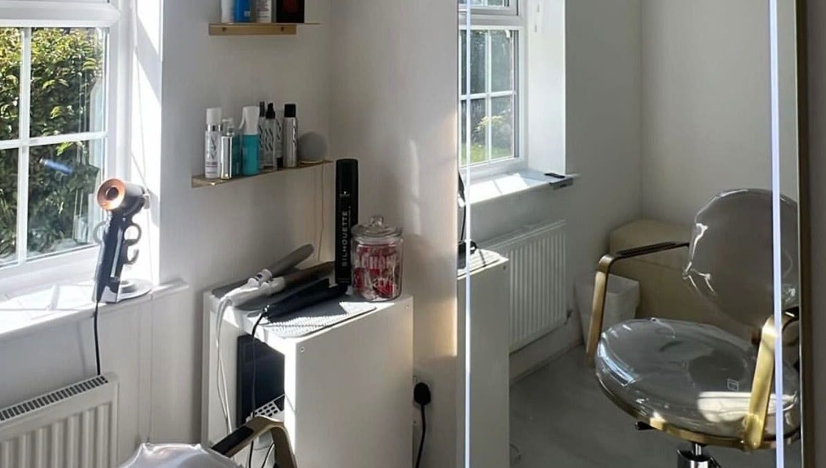 Modern salon interior at Doll Hair By Lara, Leicester, England, GB, featuring styling chair and hair products.