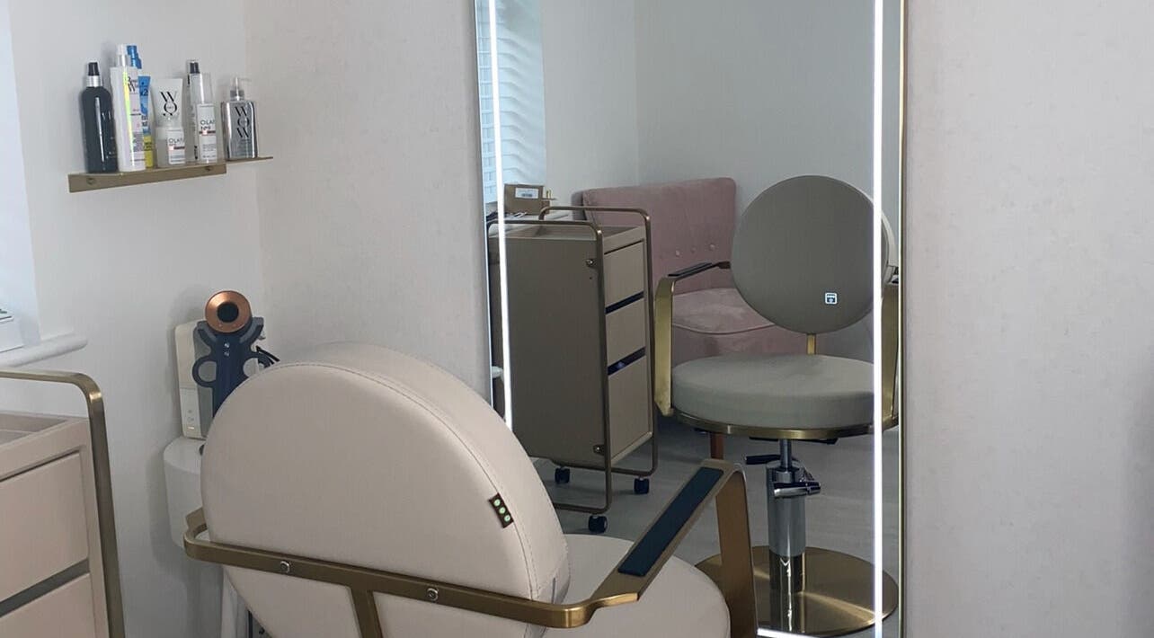 Modern salon interior at Doll Hair By Lara, Leicester, England, GB, featuring stylish seating and beauty products.