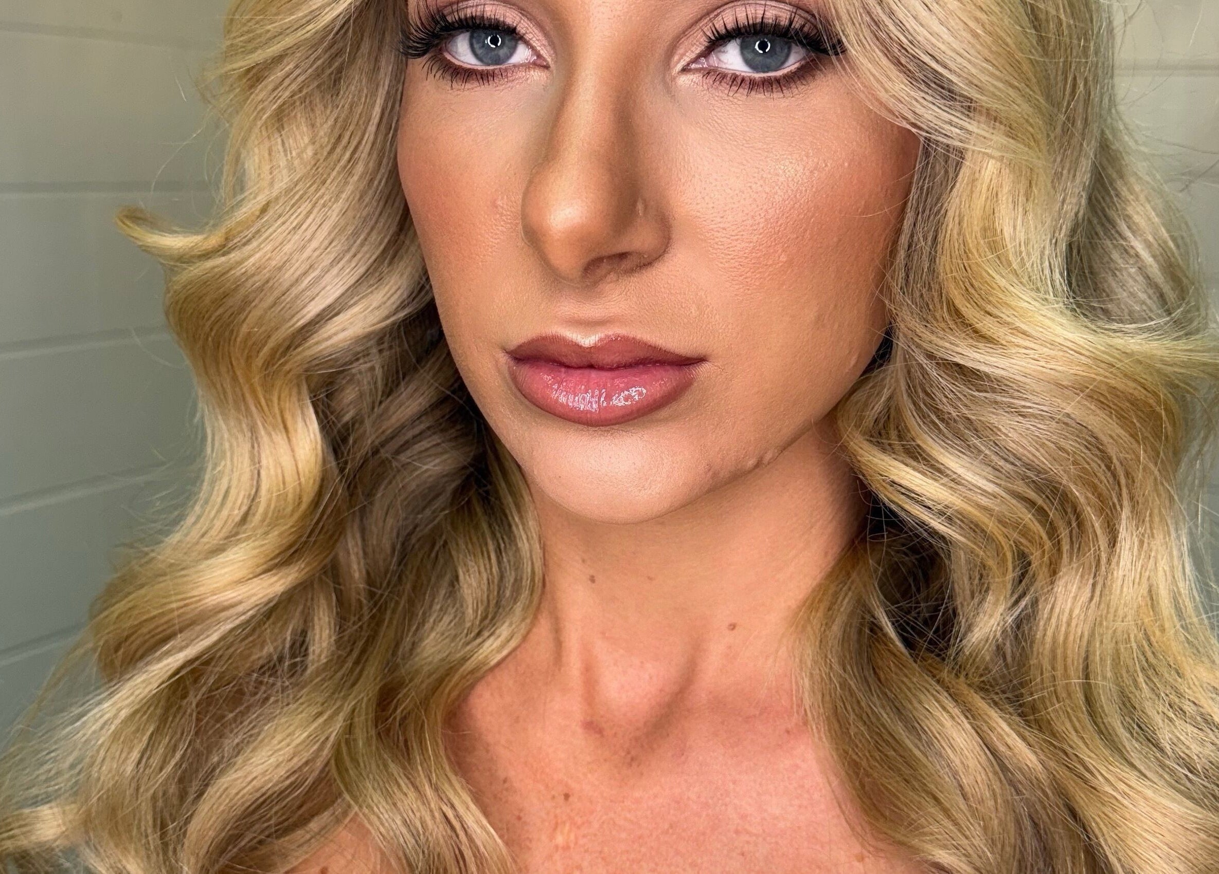 Model showcasing wavy blonde hairstyle at Blonde & Boujee Boutique, Tannum Sands, Queensland, AU.