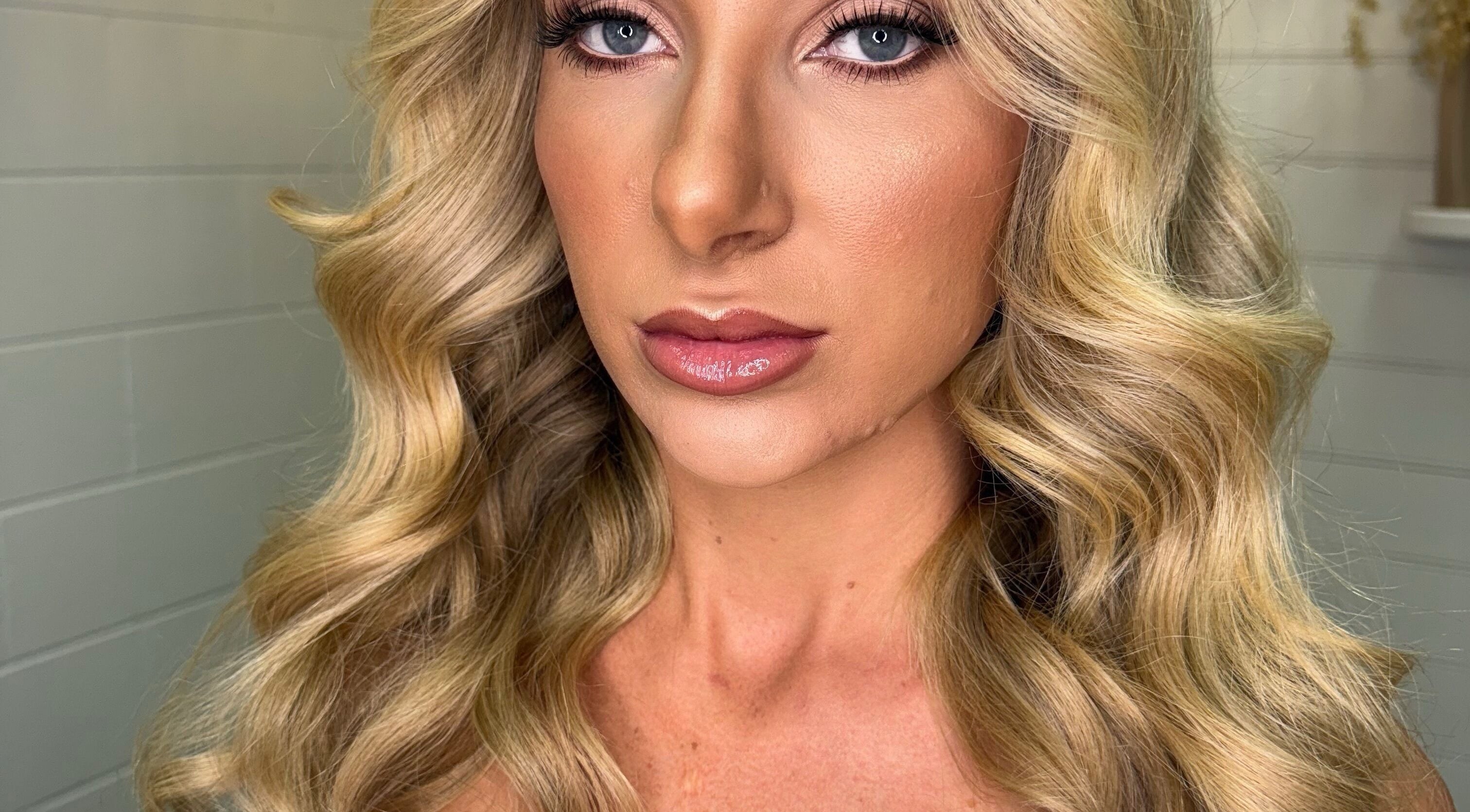 Model showcasing wavy blonde hairstyle at Blonde & Boujee Boutique, Tannum Sands, Queensland, AU.