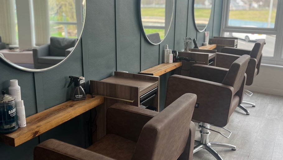 Elegant salon seating at Nv Studio, Exeter, England, GB, featuring stylish mirrors and modern furnishings.