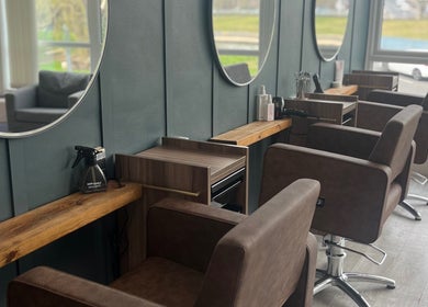 Elegant salon seating at Nv Studio, Exeter, England, GB, featuring stylish mirrors and modern furnishings.