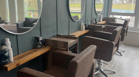 Elegant salon seating at Nv Studio, Exeter, England, GB, featuring stylish mirrors and modern furnishings.