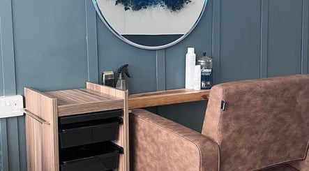 Elegant salon chair and vanity at Nv Studio, Exeter, England, GB, showcasing modern beauty equipment.