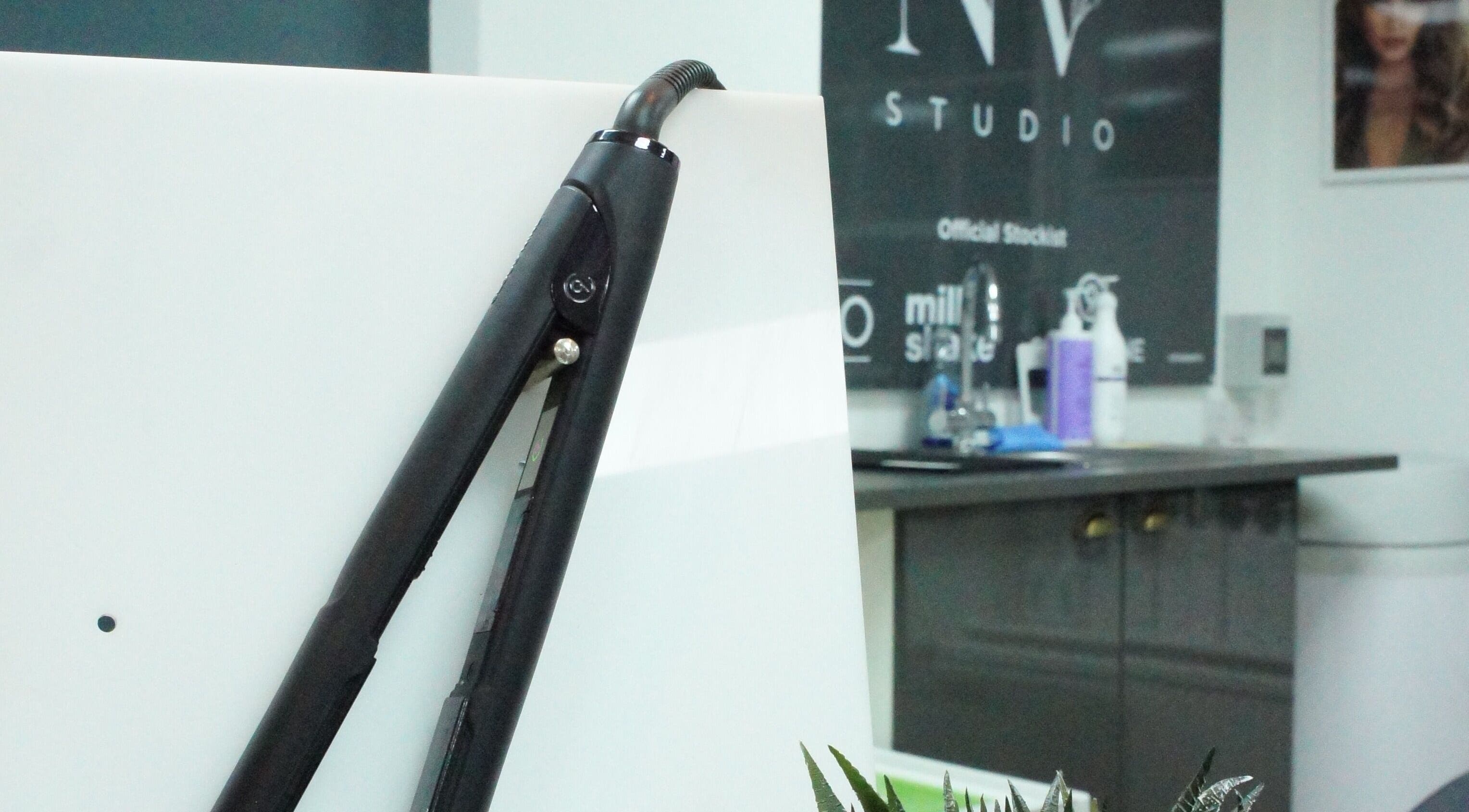 Flat iron and salon tools at Nv Studio, Exeter, England, GB, showcasing a modern beauty workspace.
