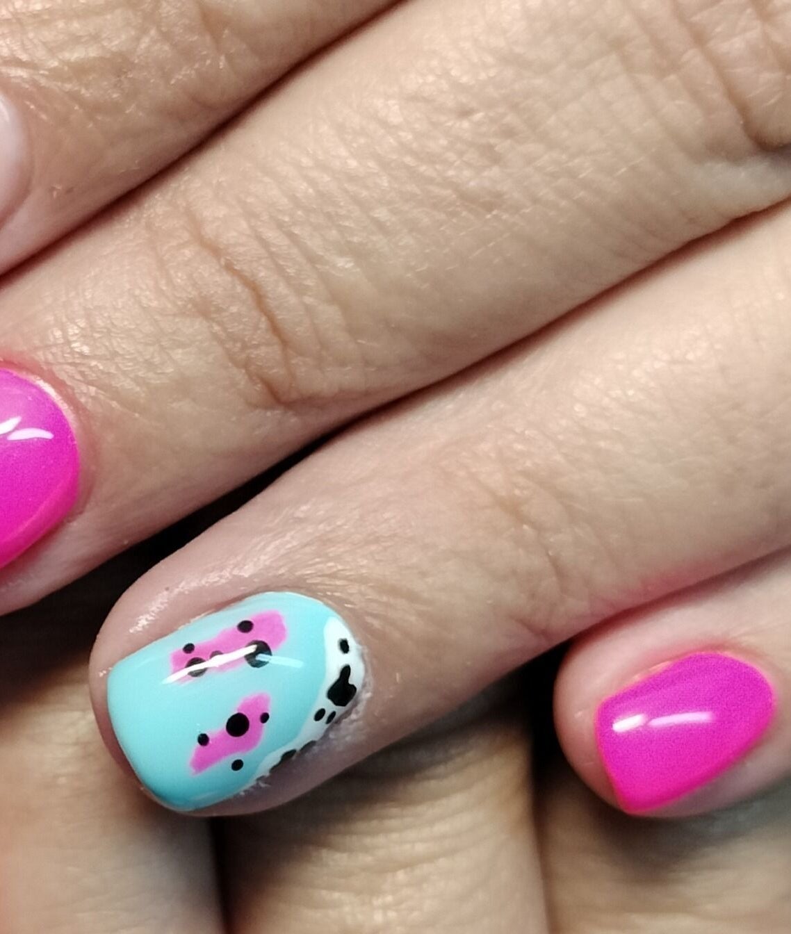 Vibrant nails at Beautify at Bella Mia, Potchefstroom, ZA, showcasing a unique pink and blue design.