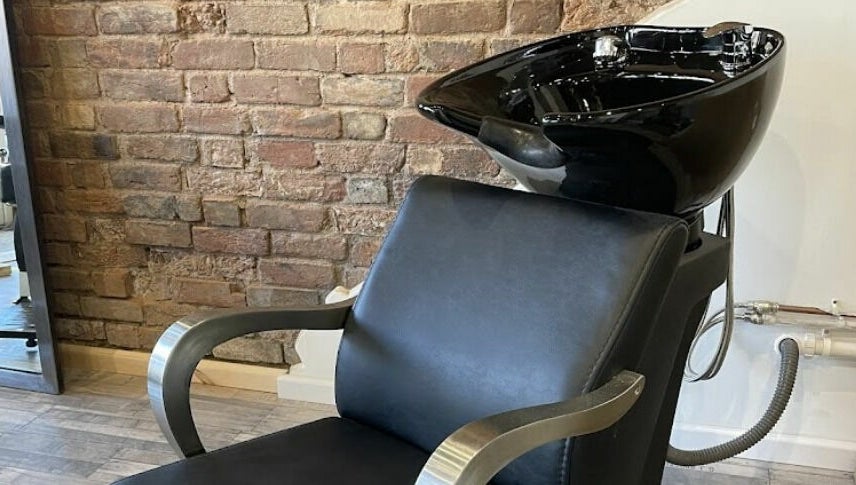 Modern hair wash station at Freestyle - Long Crendon, Long Crendon, England, GB, with brick wall backdrop.