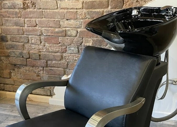 Modern hair wash station at Freestyle - Long Crendon, Long Crendon, England, GB, with brick wall backdrop.