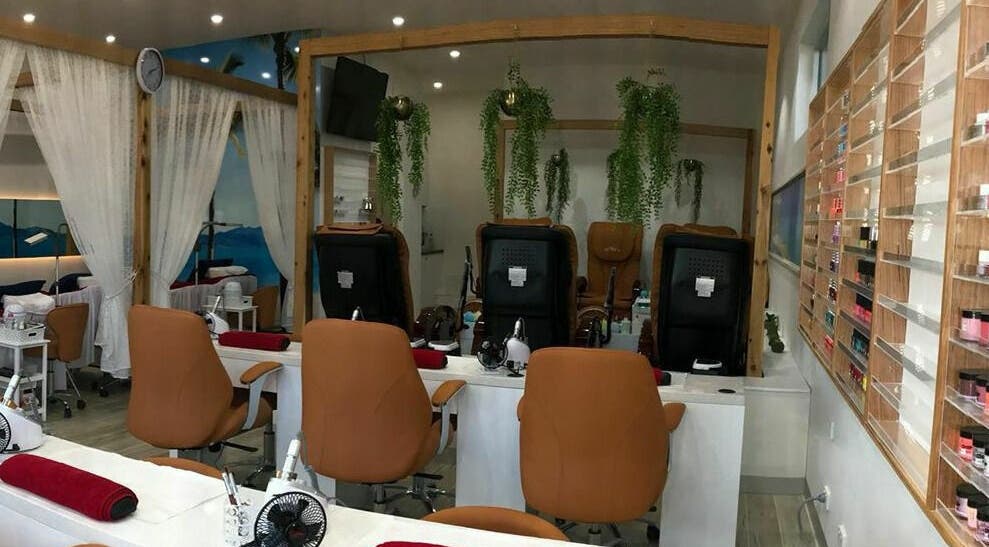 Modern nail station at 81 Nails & Beauty, Ocean Grove, Victoria, AU, featuring cozy chairs and lush greenery.