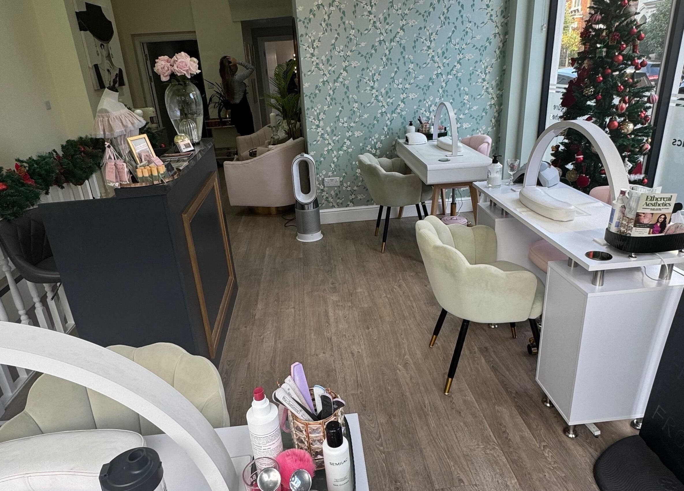 Elegant interior of GLAM FACES CLINIC in London, England, GB showcasing nail stations and festive decor.