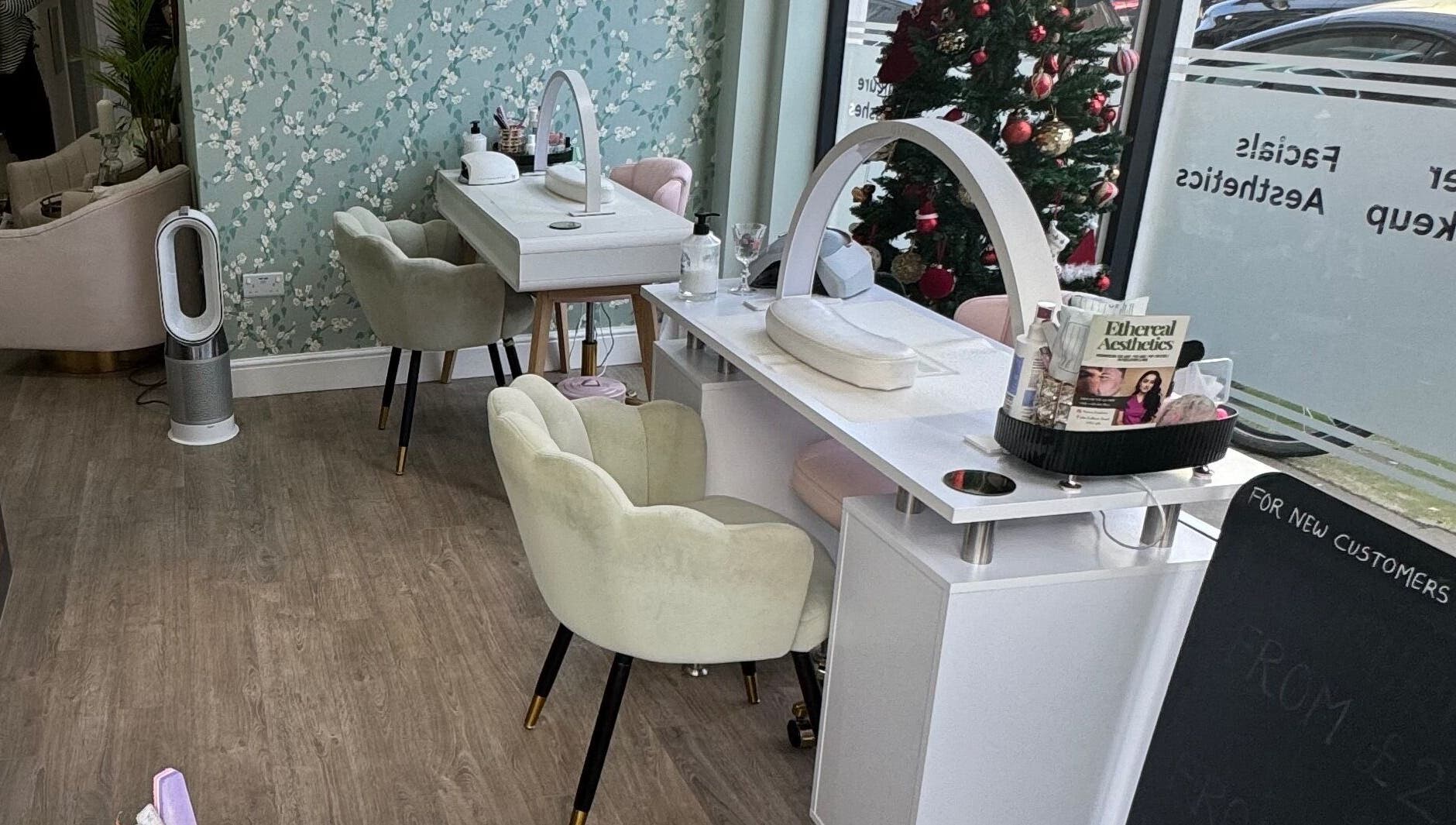 Elegant nail salon setup at GLAM FACES CLINIC, London, England, GB with stylish chairs and decor.
