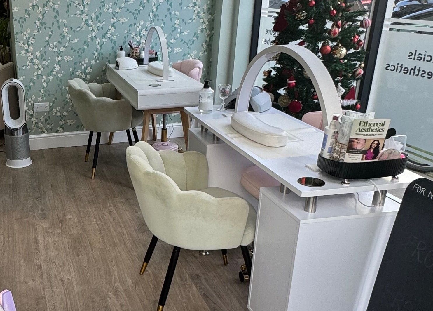 Elegant nail salon setup at GLAM FACES CLINIC, London, England, GB with stylish chairs and decor.