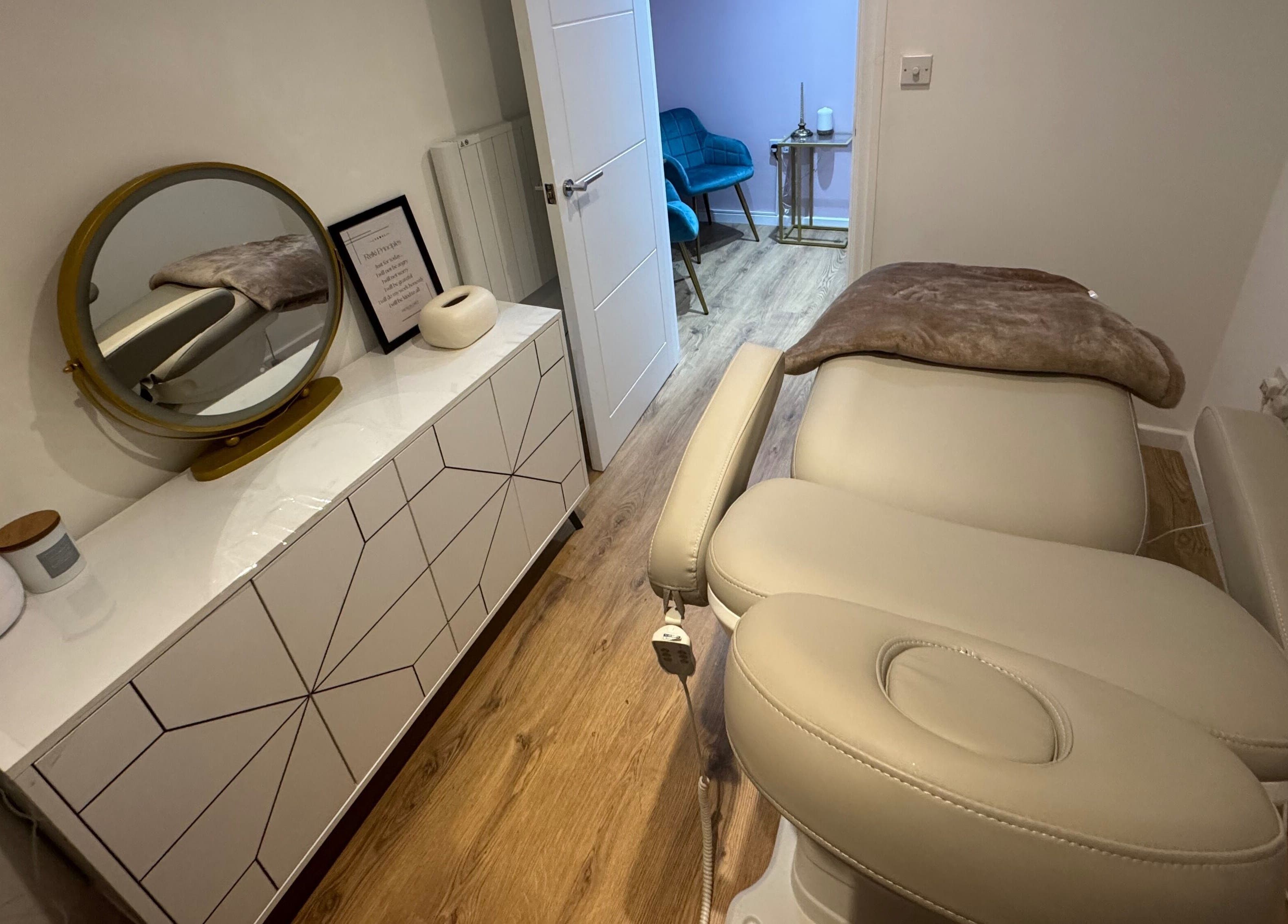 Serene spa room at GLAM FACES CLINIC, featuring a treatment bed and modern decor in London, England, GB.