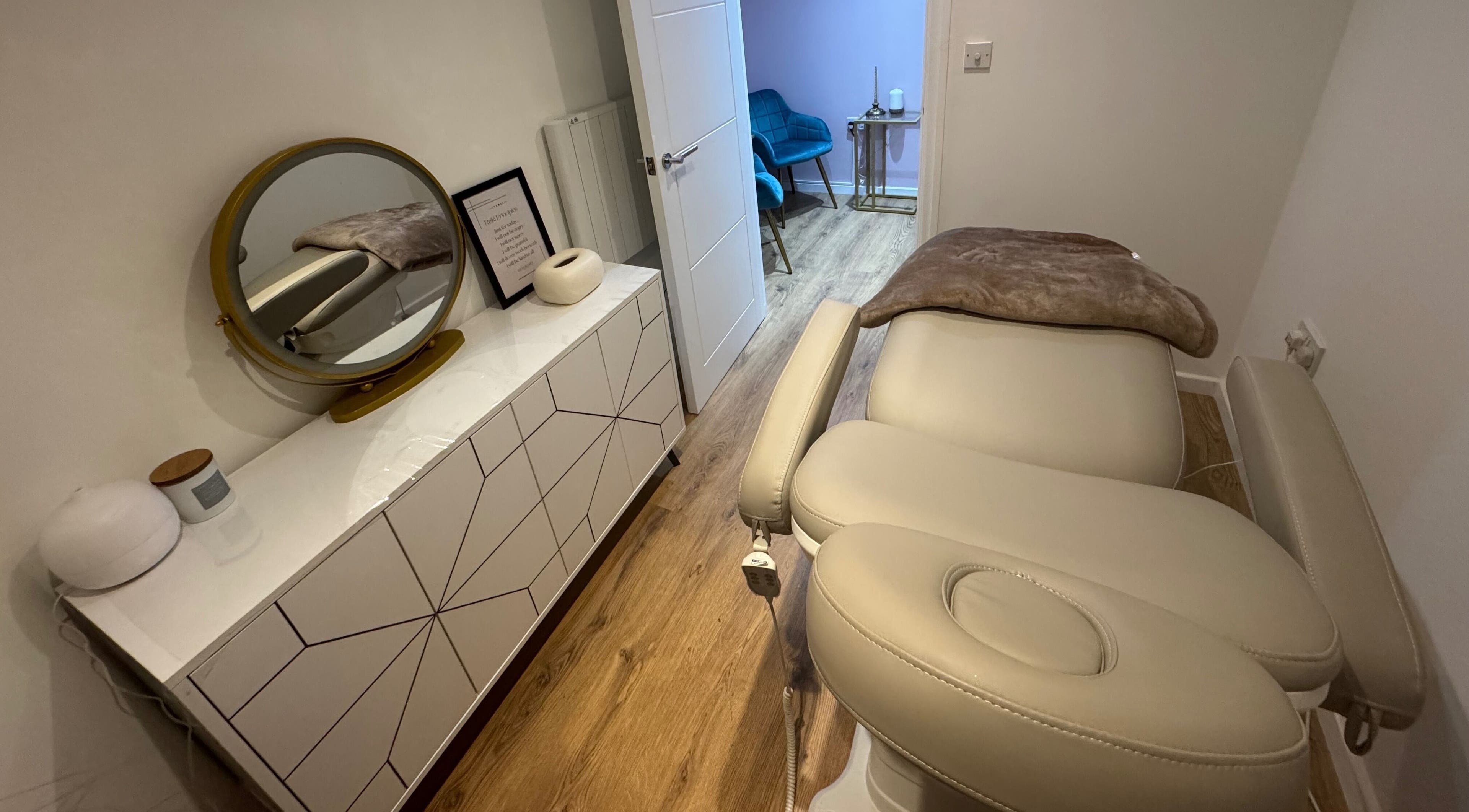 Serene spa room at GLAM FACES CLINIC, featuring a treatment bed and modern decor in London, England, GB.