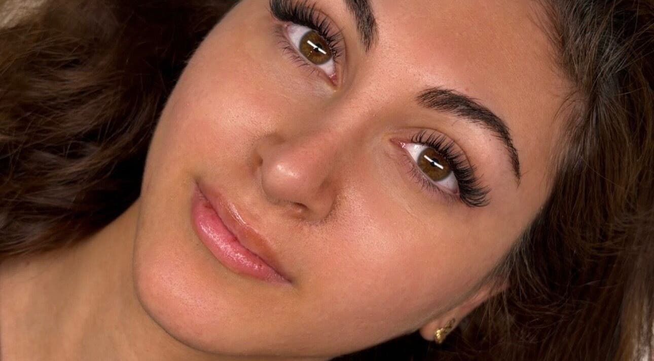 Close-up of a model's radiant face highlighting lashes at GLAM FACES CLINIC, London, England, GB.