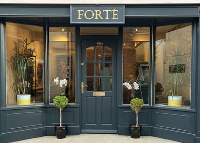 Front entrance of Forté in Louth, England, GB, showcasing sleek design and lush plants.