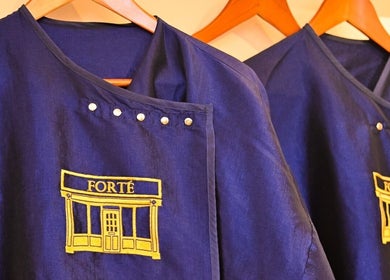 Elegant blue tunics with Forté logo, Louth, England, GB, highlight brand identity.
