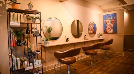 Chic salon interior at Forté, Louth, England, GB, featuring stylish chairs and artistic decor.