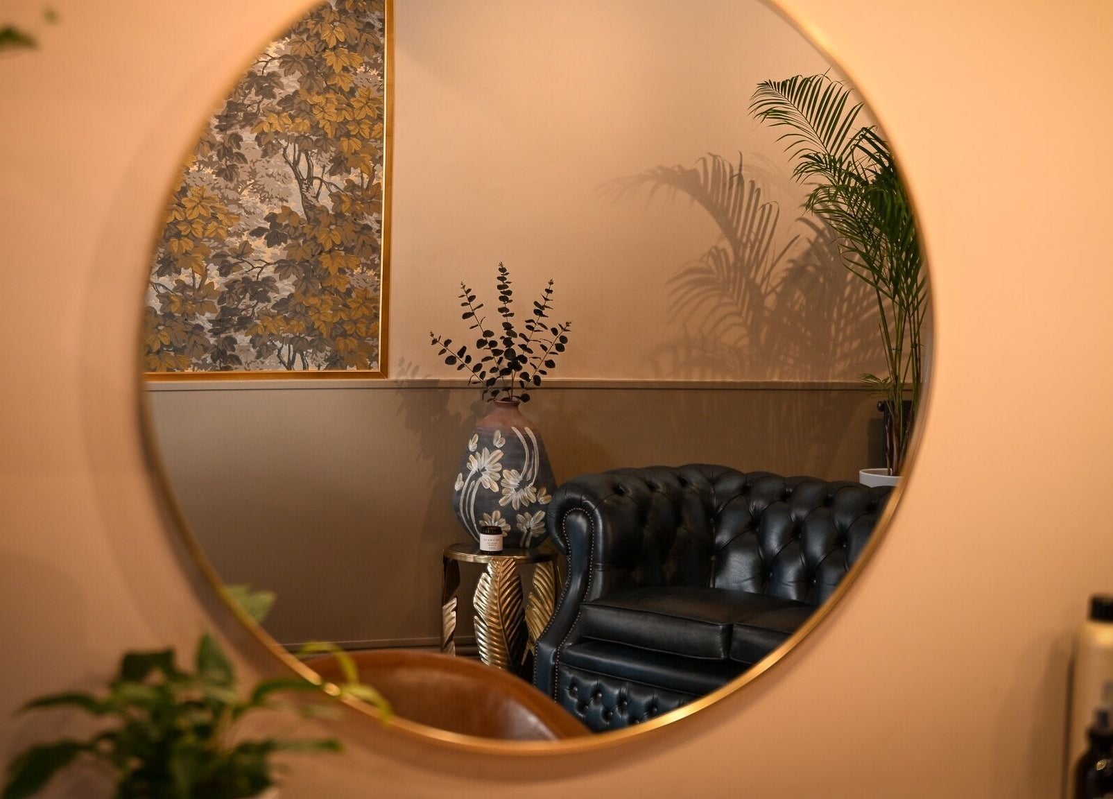 Cozy seating area with wall art seen in circular mirror at Forté, Louth, England, GB.