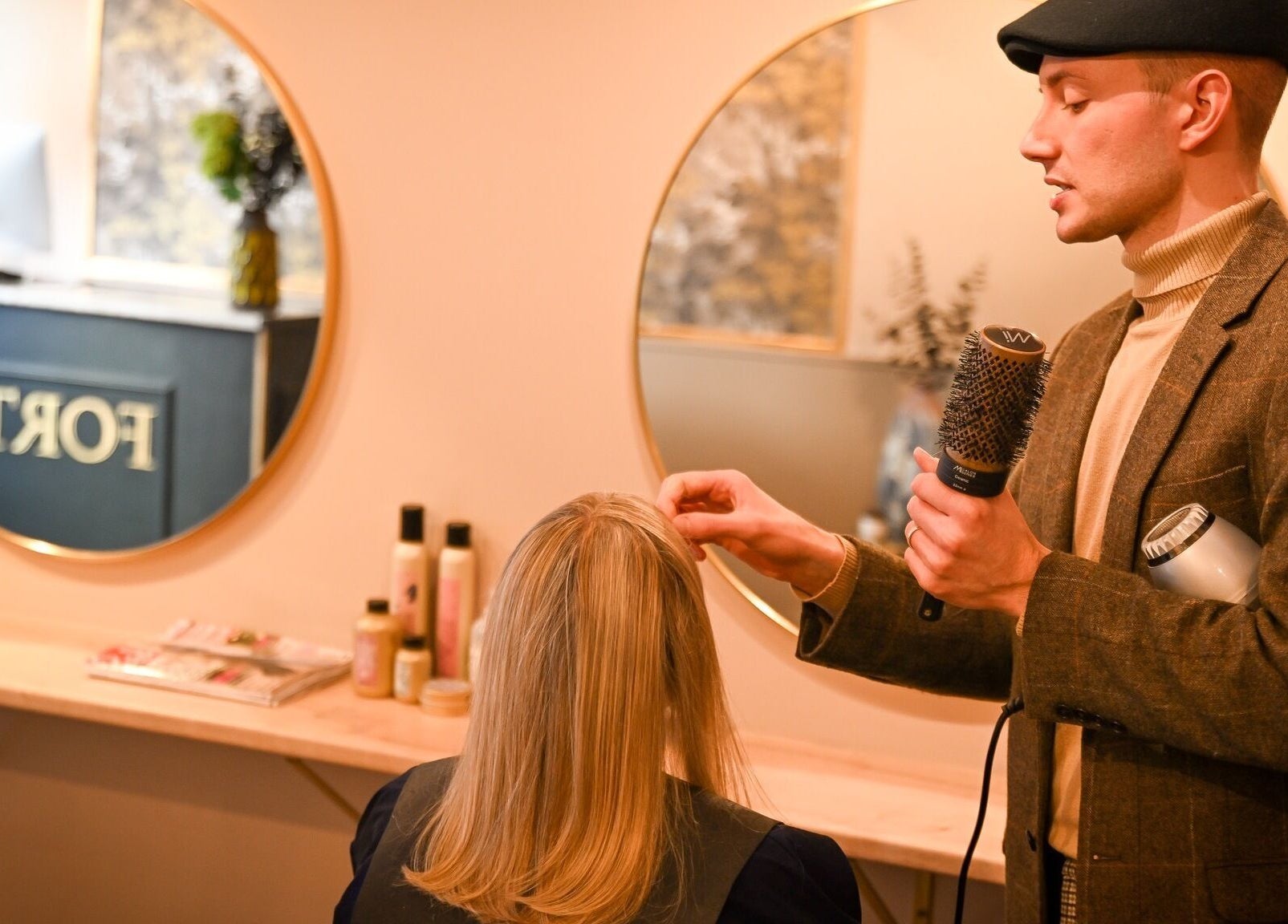 Professional stylist at Forté salon in Louth, England, GB, shaping client's hair with finesse and style.