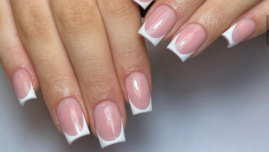 Beautiful French manicure at Lux Beauty, Cannock, England, GB. Perfectly polished nails in close-up.