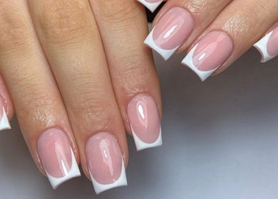 Beautiful French manicure at Lux Beauty, Cannock, England, GB. Perfectly polished nails in close-up.